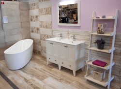 Kúpeľňa v štýle Provence s oválnou vaňou, bielou skrinkou s dvoma umývadlami a otvoreným regálom na dekorácie a uteráky
