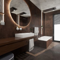 Luxusná kúpeľňa v tmavo hnedých tónoch s veľkým kruhovým zrkadlom, umývadlom na dlhej doske a obmurovanou vaňou v zadnej časti