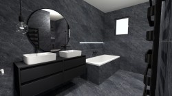 Kúpeľňa v tmavom kamennom dekore s dvojicou bielych umývadiel na čiernej skrinke, veľkým okrúhlym zrkadlom a vstavanou vaňou